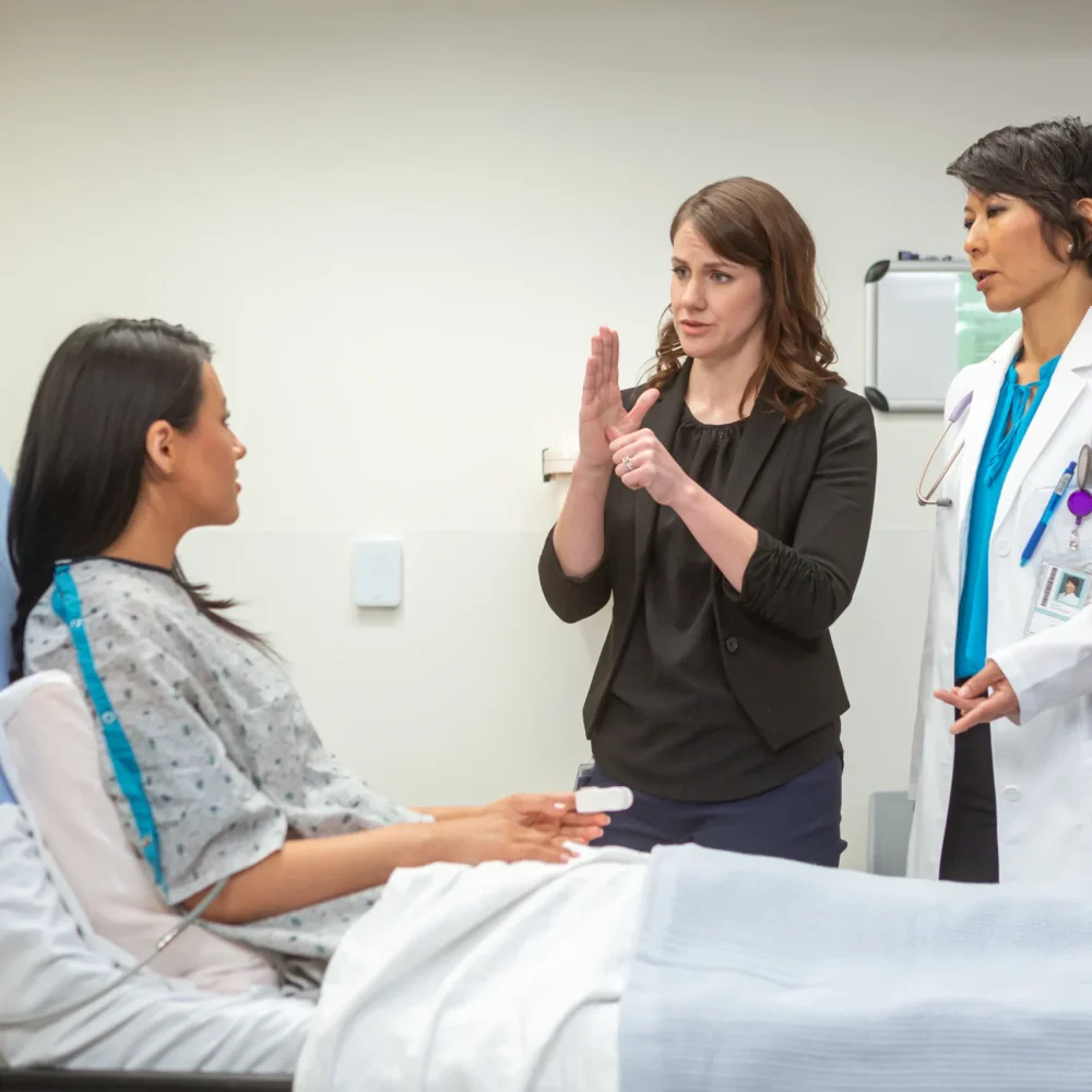medical-interpreter-working-with-a-patient-and-clinician-in-a-healthcare-environment